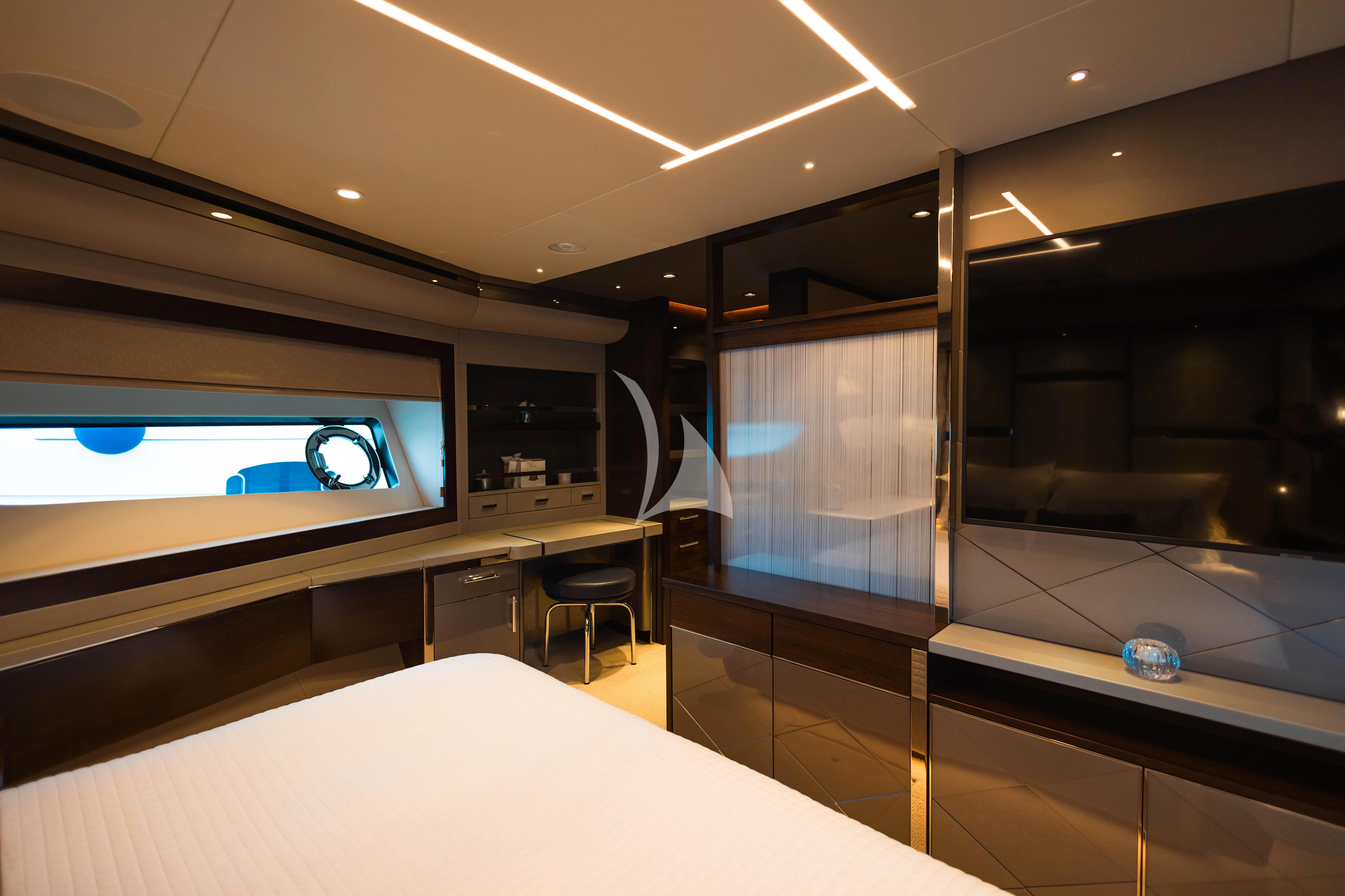 a room with a large television and a table with chairs aboard MOONLIGHT Yacht for Sale
