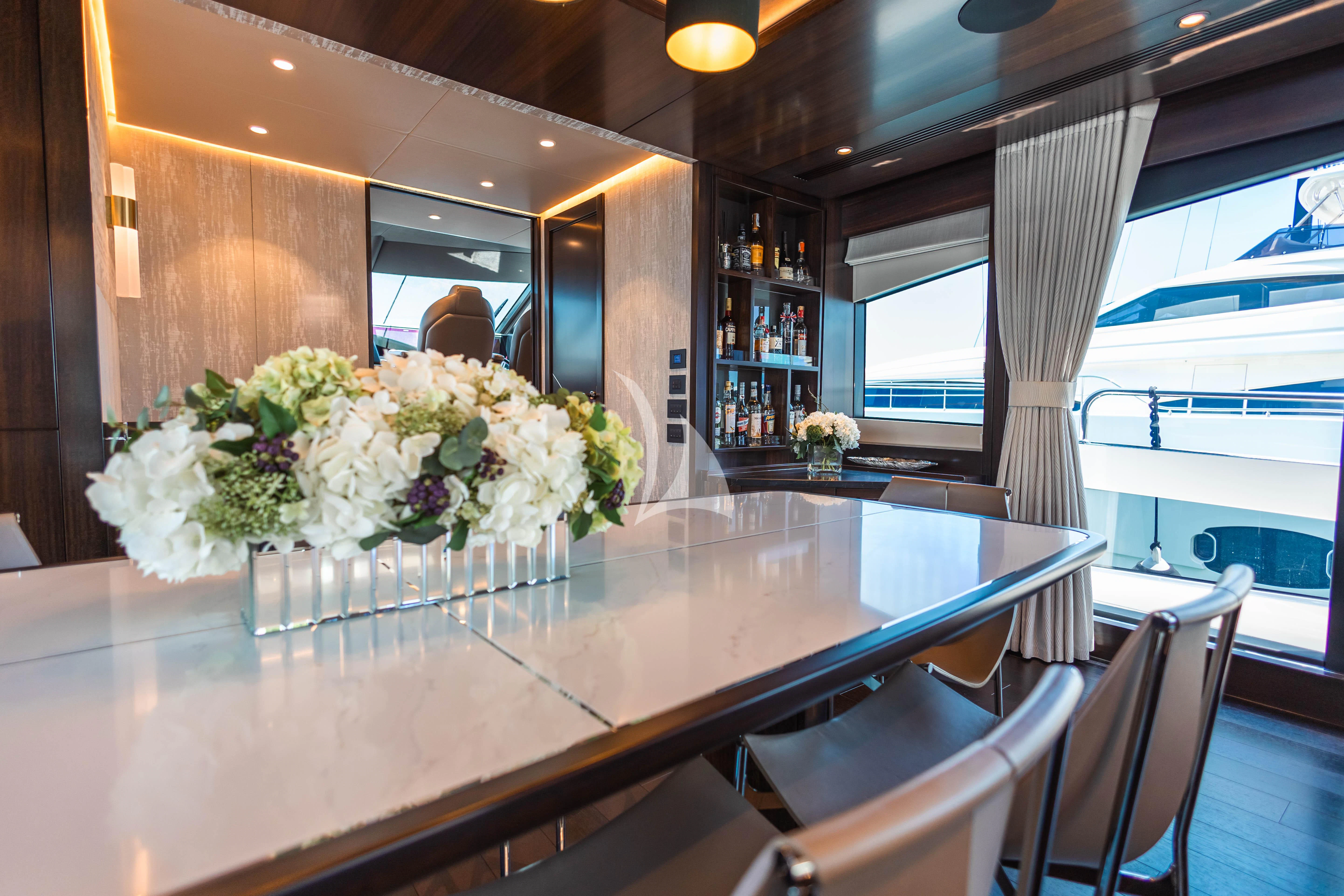 a table with flowers on it aboard MOONLIGHT Yacht for Sale