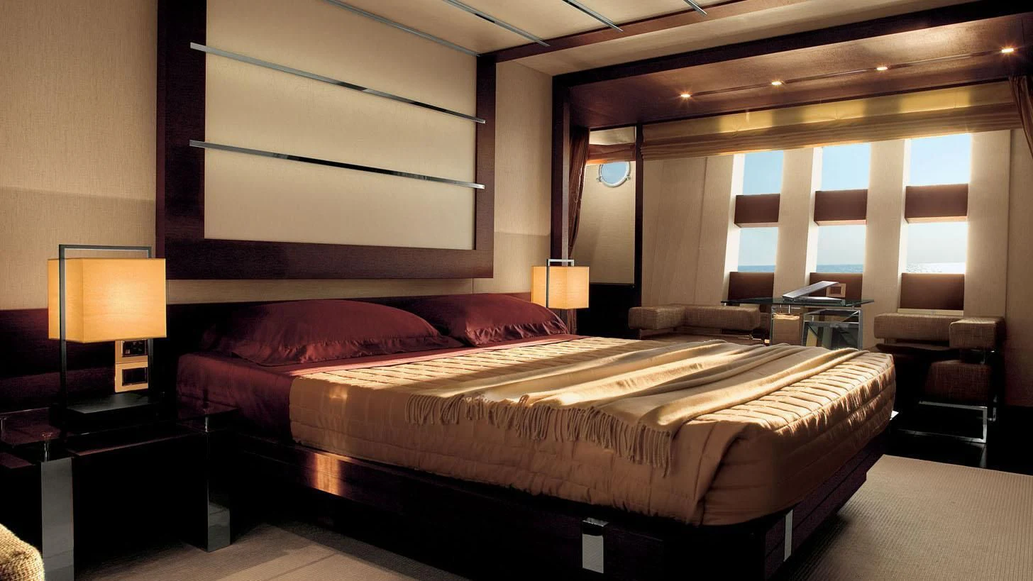a large bed in a hotel room aboard DUKE Yacht for Sale