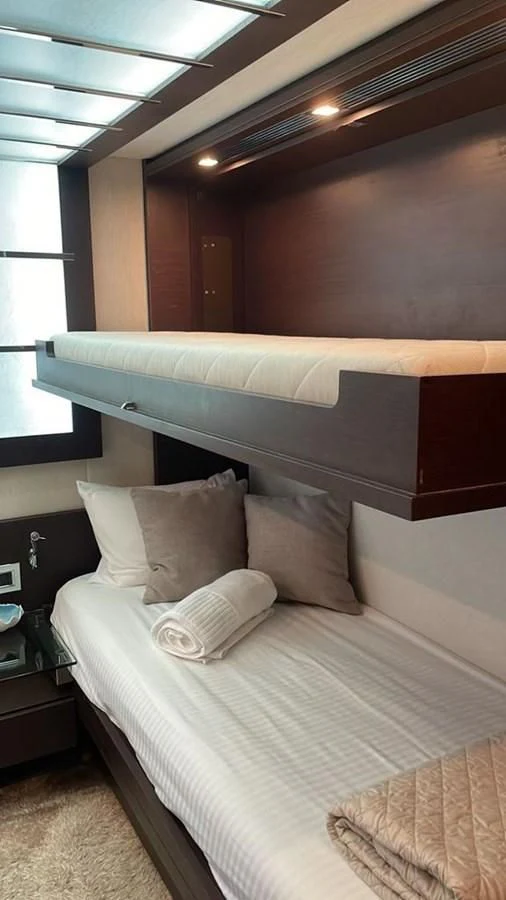 a bed with white sheets aboard DUKE Yacht for Sale