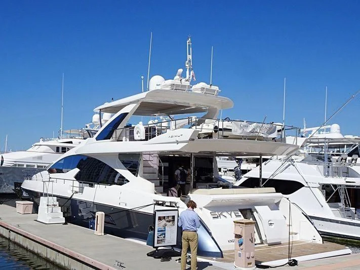 a large white boat with a few people standing on it aboard SKYE Yacht for Sale