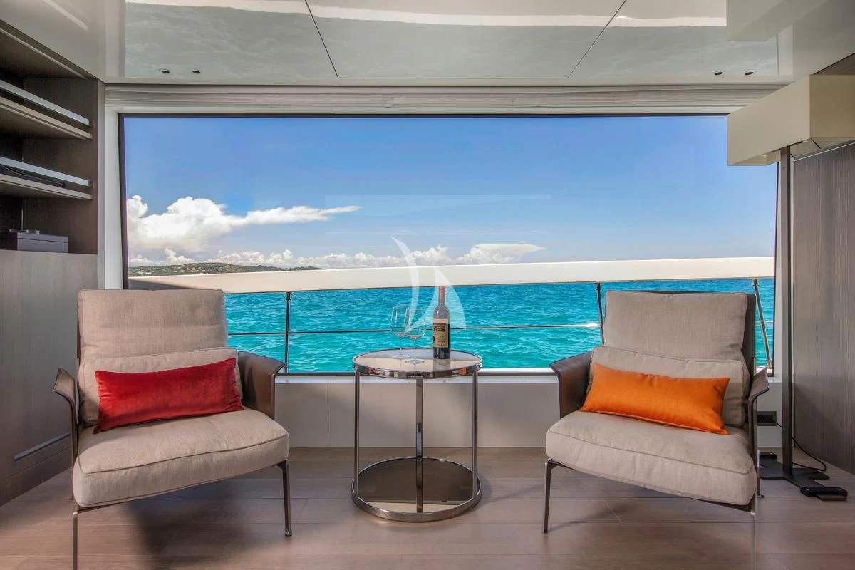 a room with a table and chairs and a glass window aboard VINCI II Yacht for Sale