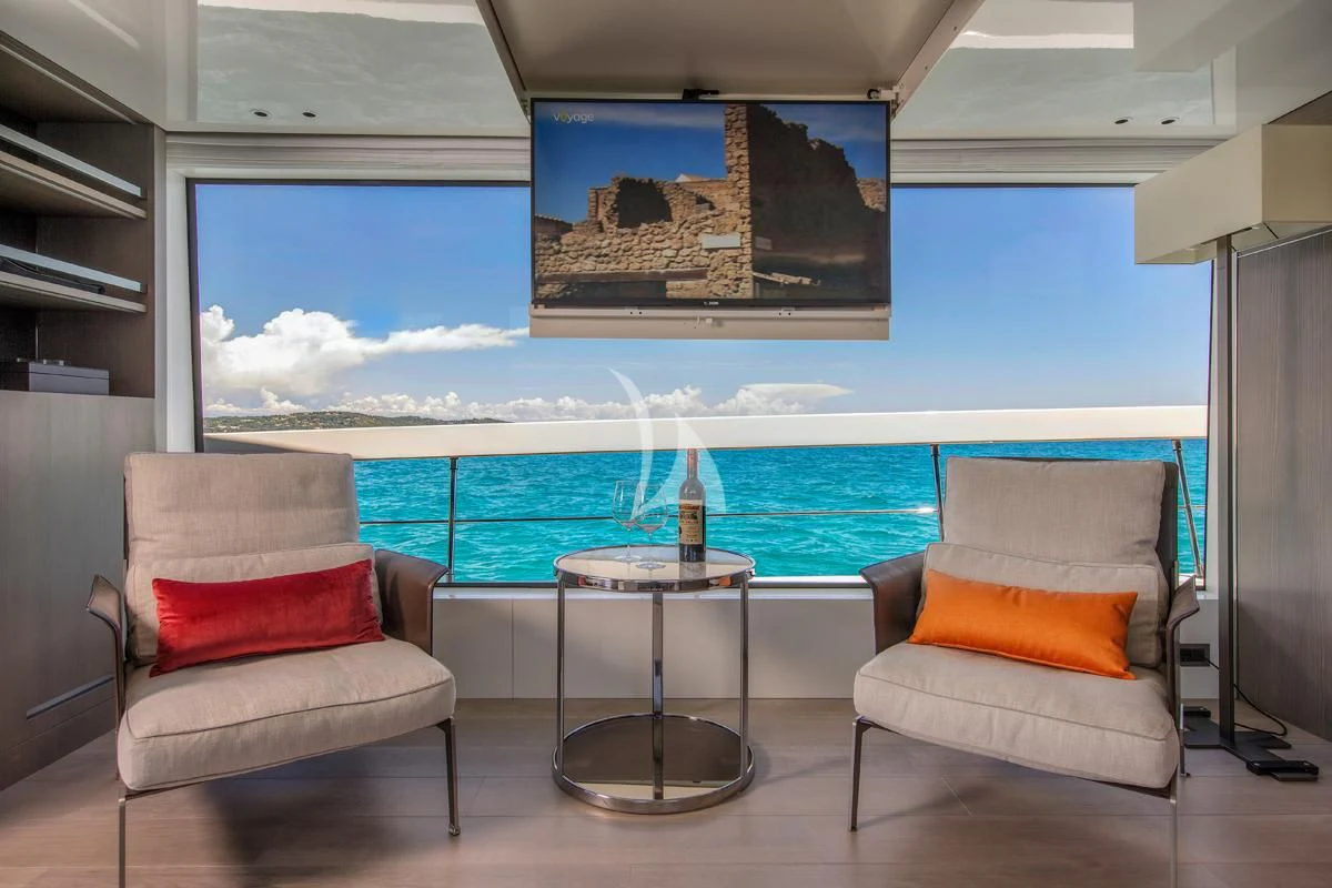a room with a table chairs and a glass window aboard VINCI II Yacht for Sale