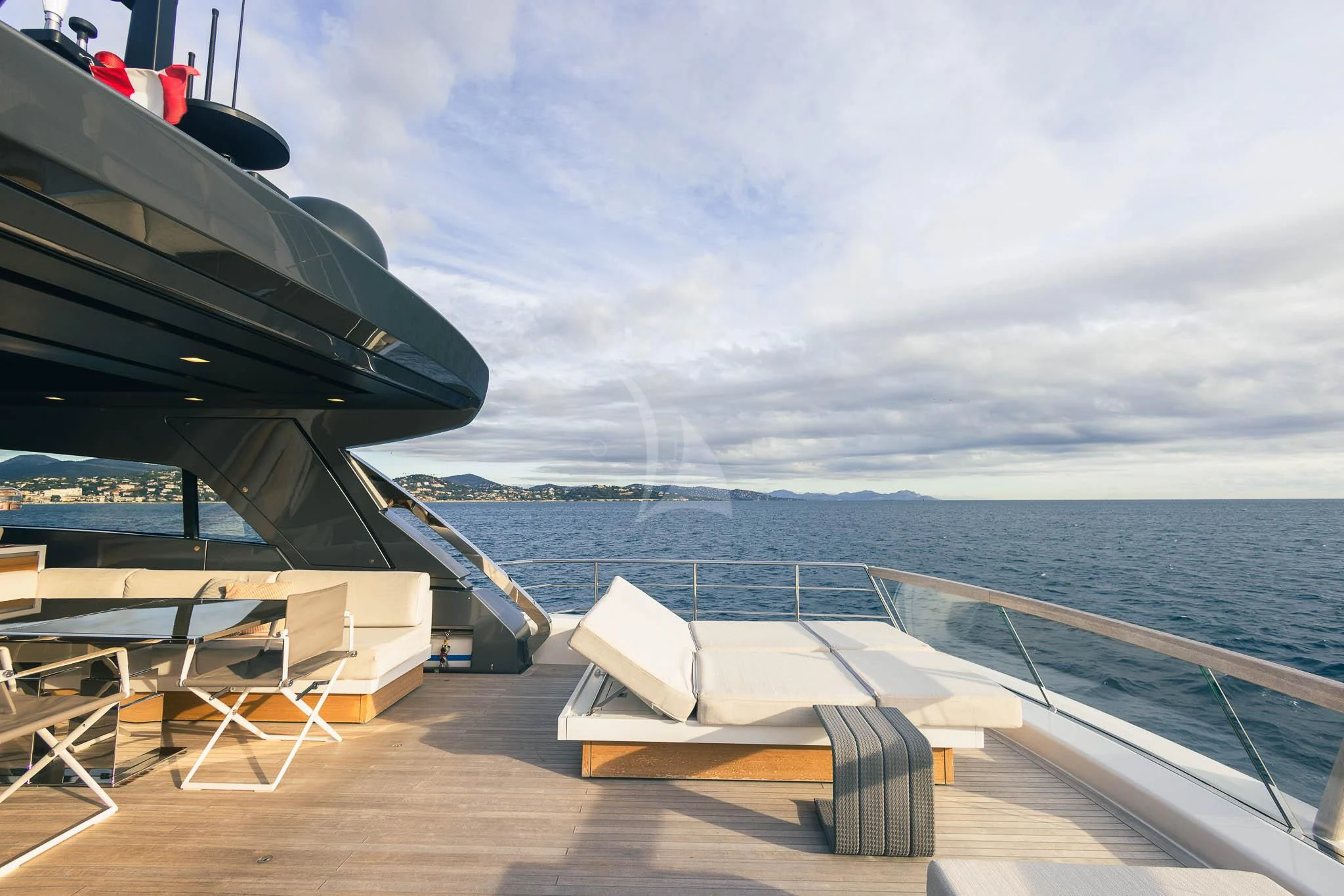 a deck with chairs and a boat on it aboard VINCI II Yacht for Sale