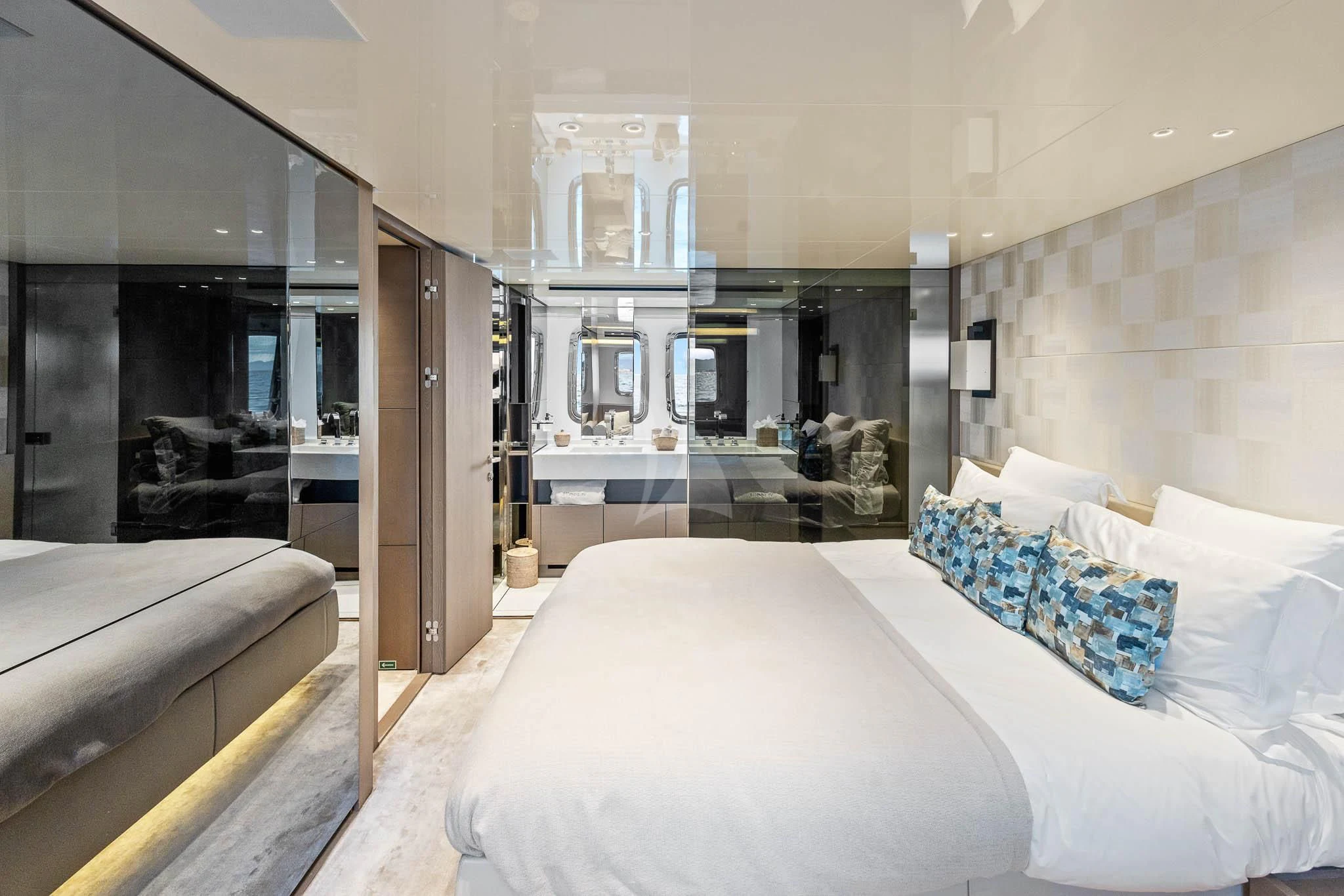 a bedroom with a large mirror aboard VINCI II Yacht for Sale