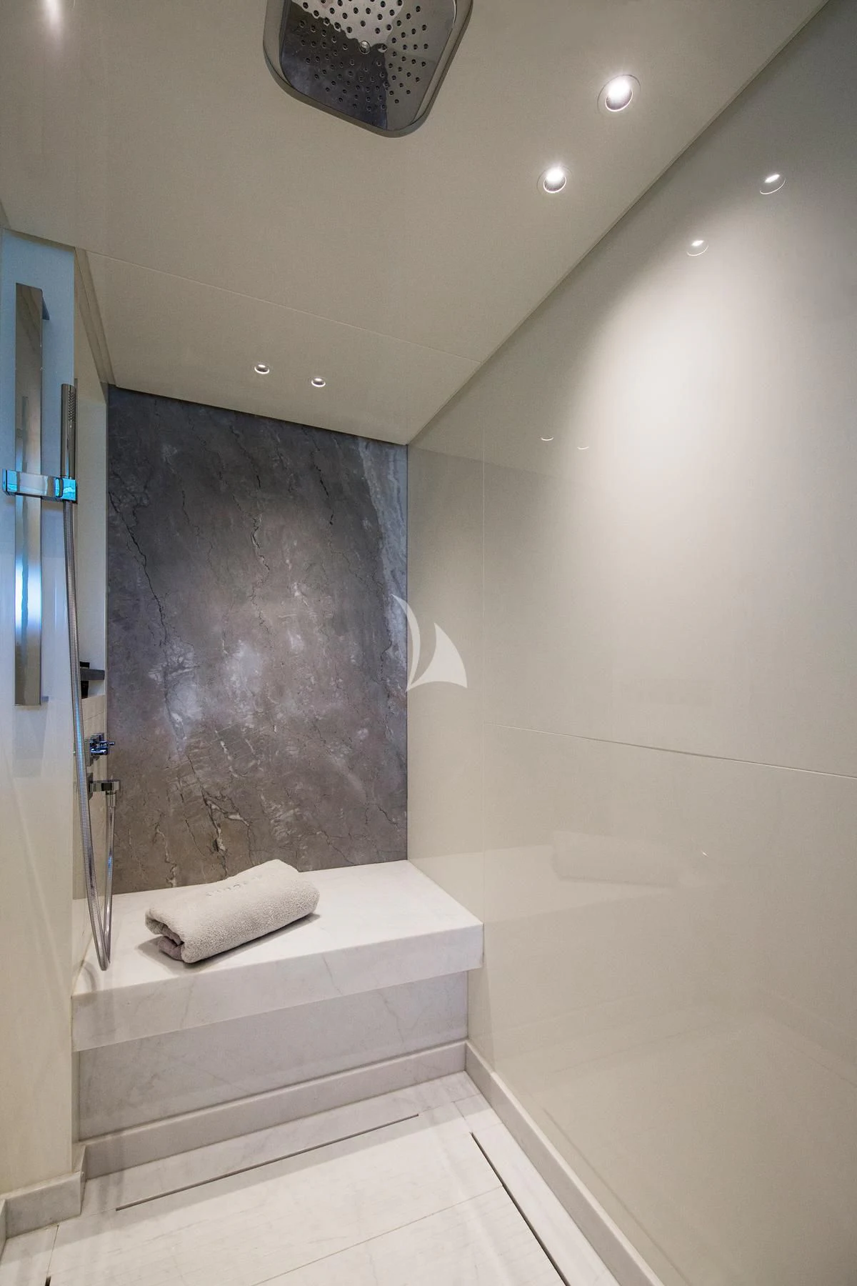 a bathroom with a marble wall aboard VINCI II Yacht for Sale