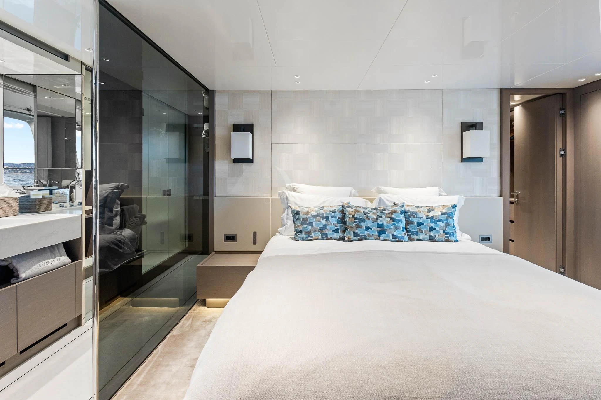 a bedroom with a bed and a mirror aboard VINCI II Yacht for Sale