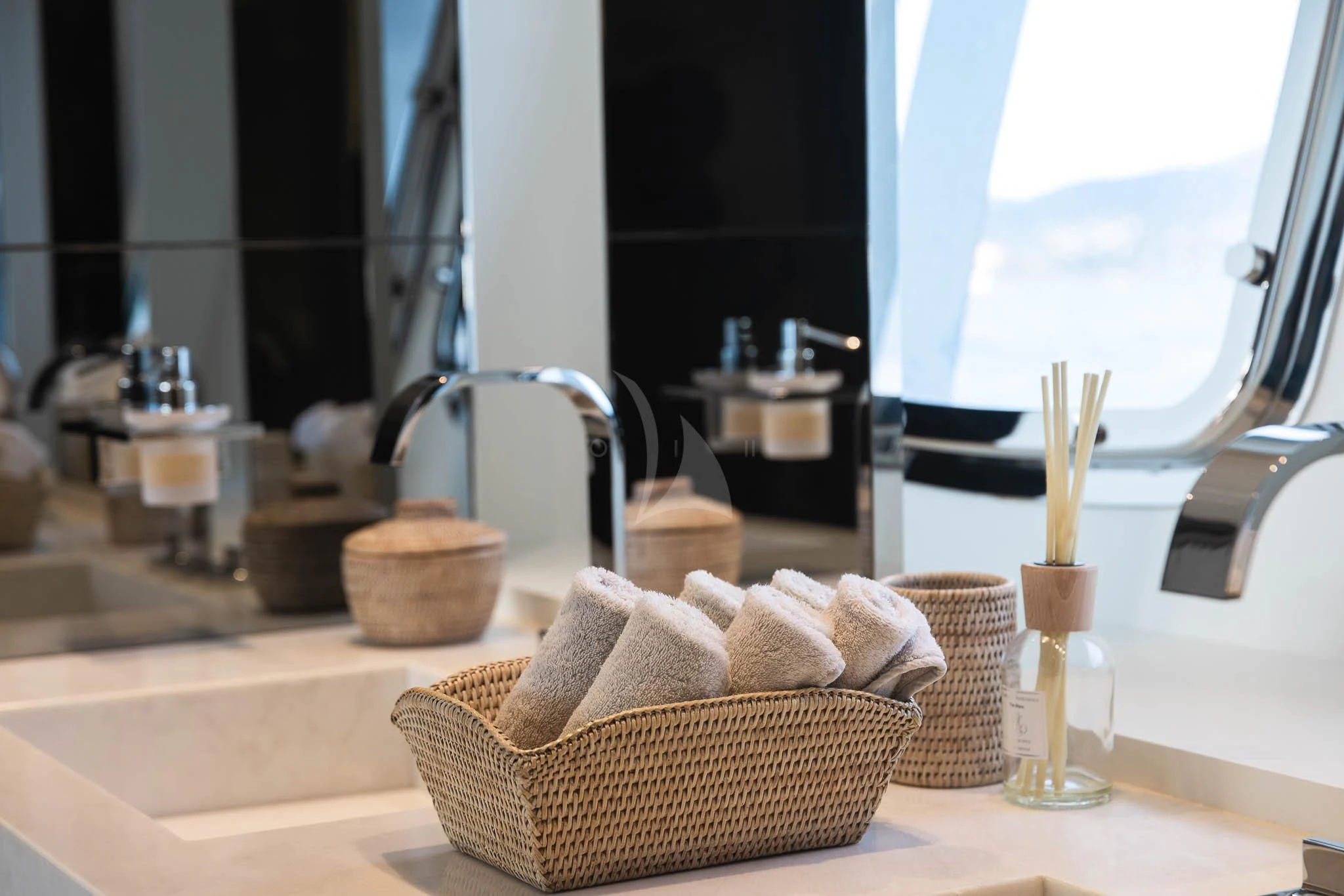 a bathroom with a sink and a basket aboard VINCI II Yacht for Sale