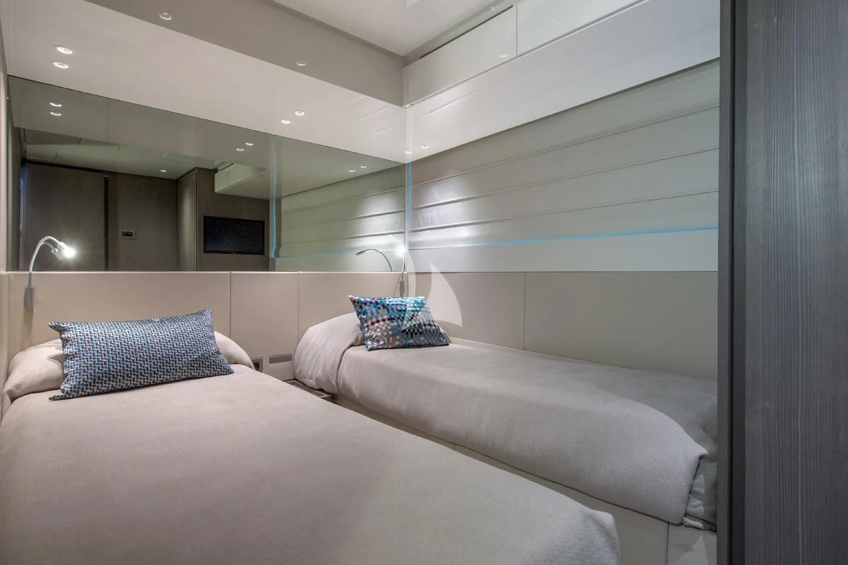 a bed with a white bed spread aboard VINCI II Yacht for Sale