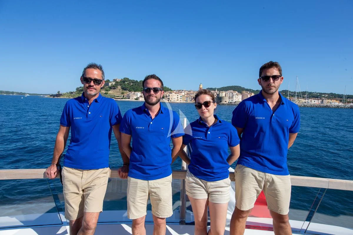 a group of men posing for a photo on a boat aboard VINCI II Yacht for Sale