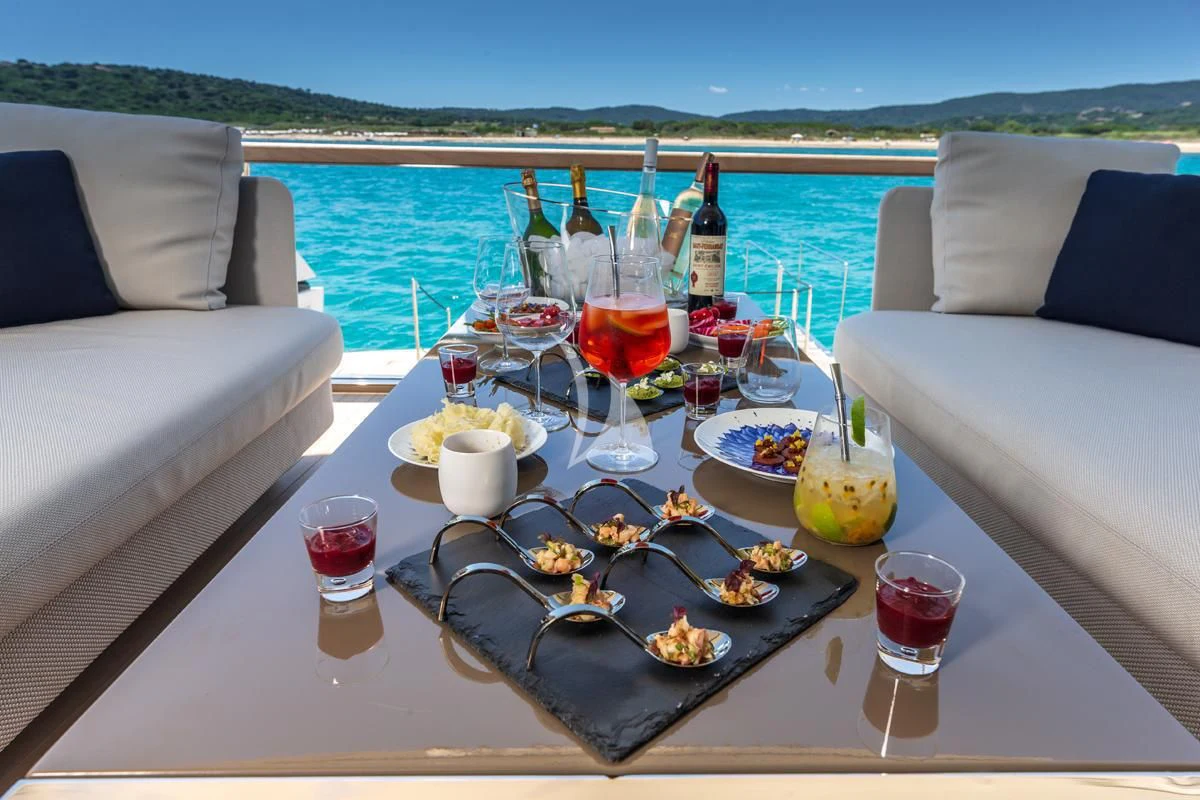 a table with food and drinks on it aboard VINCI II Yacht for Sale
