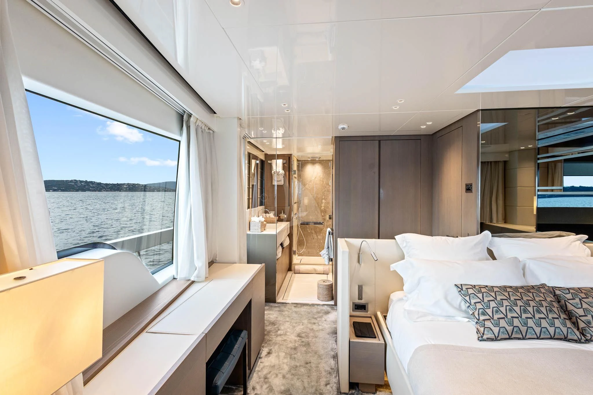 a room with a bed and a window aboard VINCI II Yacht for Sale