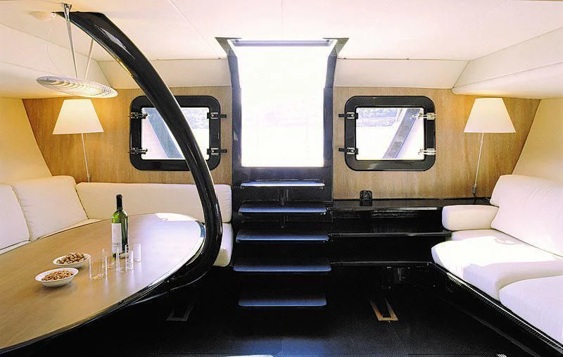 a room with a bed and a table aboard TIKETITAN Yacht for Sale