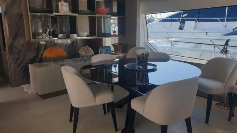 a room with tables and chairs aboard HANAVA Yacht for Sale