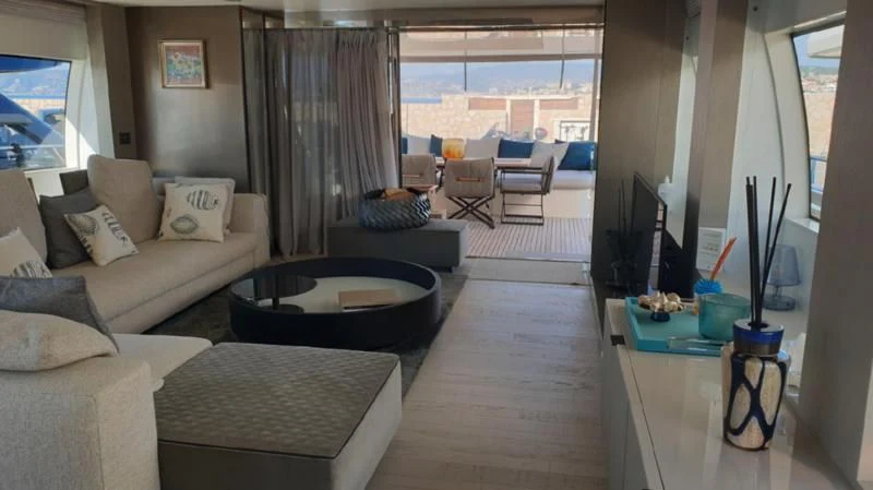a living room with a large window aboard HANAVA Yacht for Sale