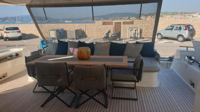 a table with chairs on it aboard HANAVA Yacht for Sale