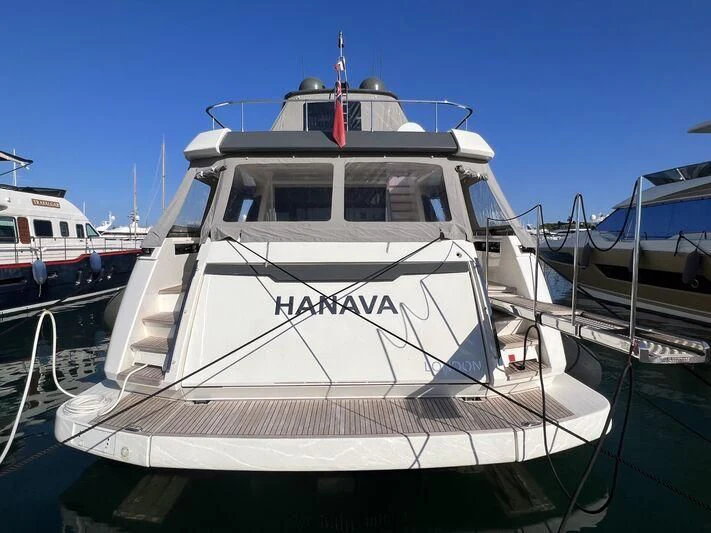a white boat in a harbor aboard HANAVA Yacht for Sale