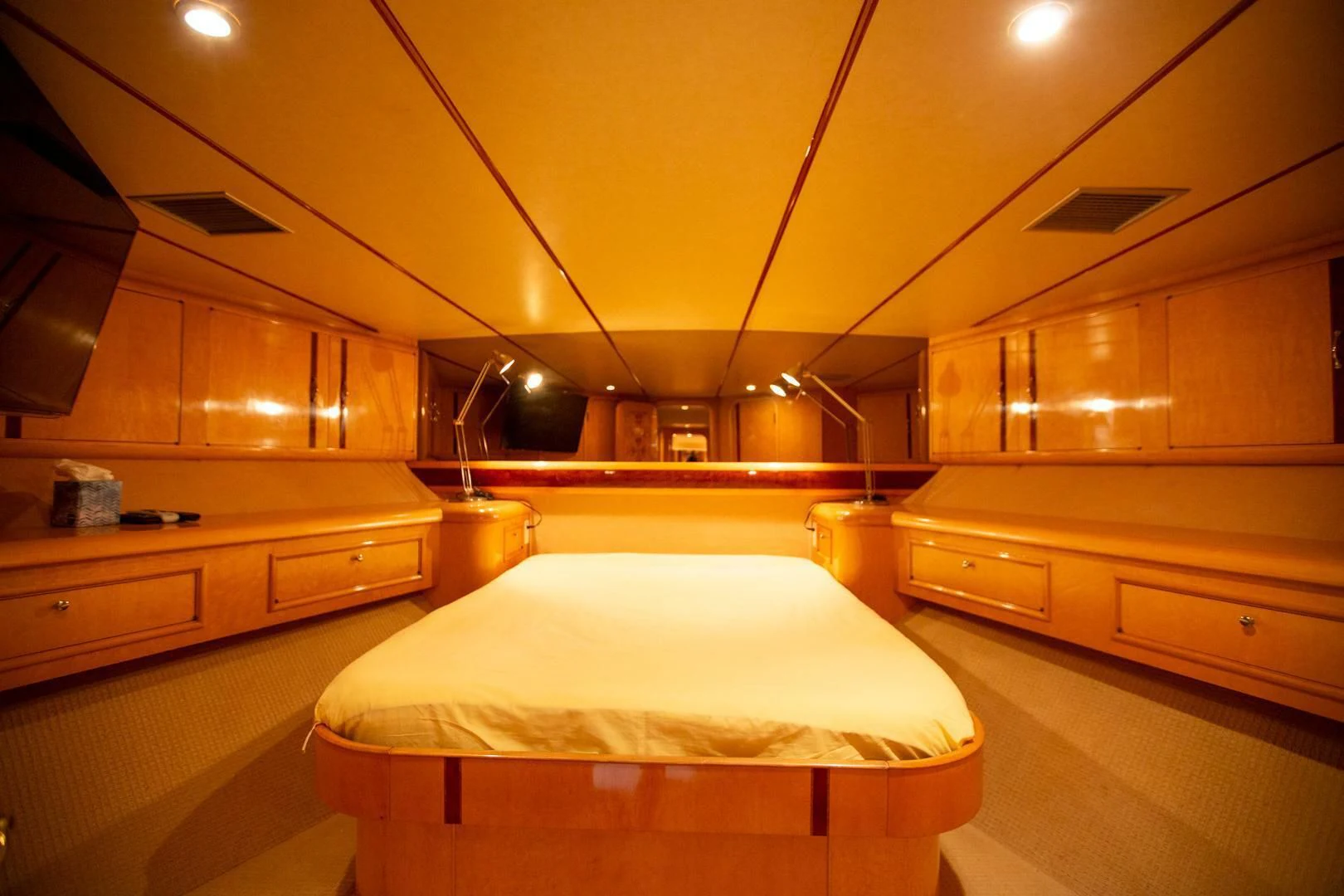 a room with a bed and cabinets aboard PAINKILLER Yacht for Sale