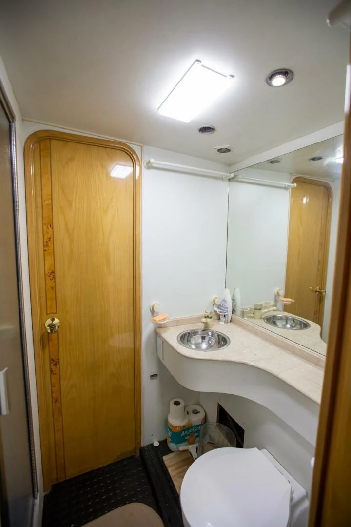a bathroom with a sink and a toilet aboard PAINKILLER Yacht for Sale