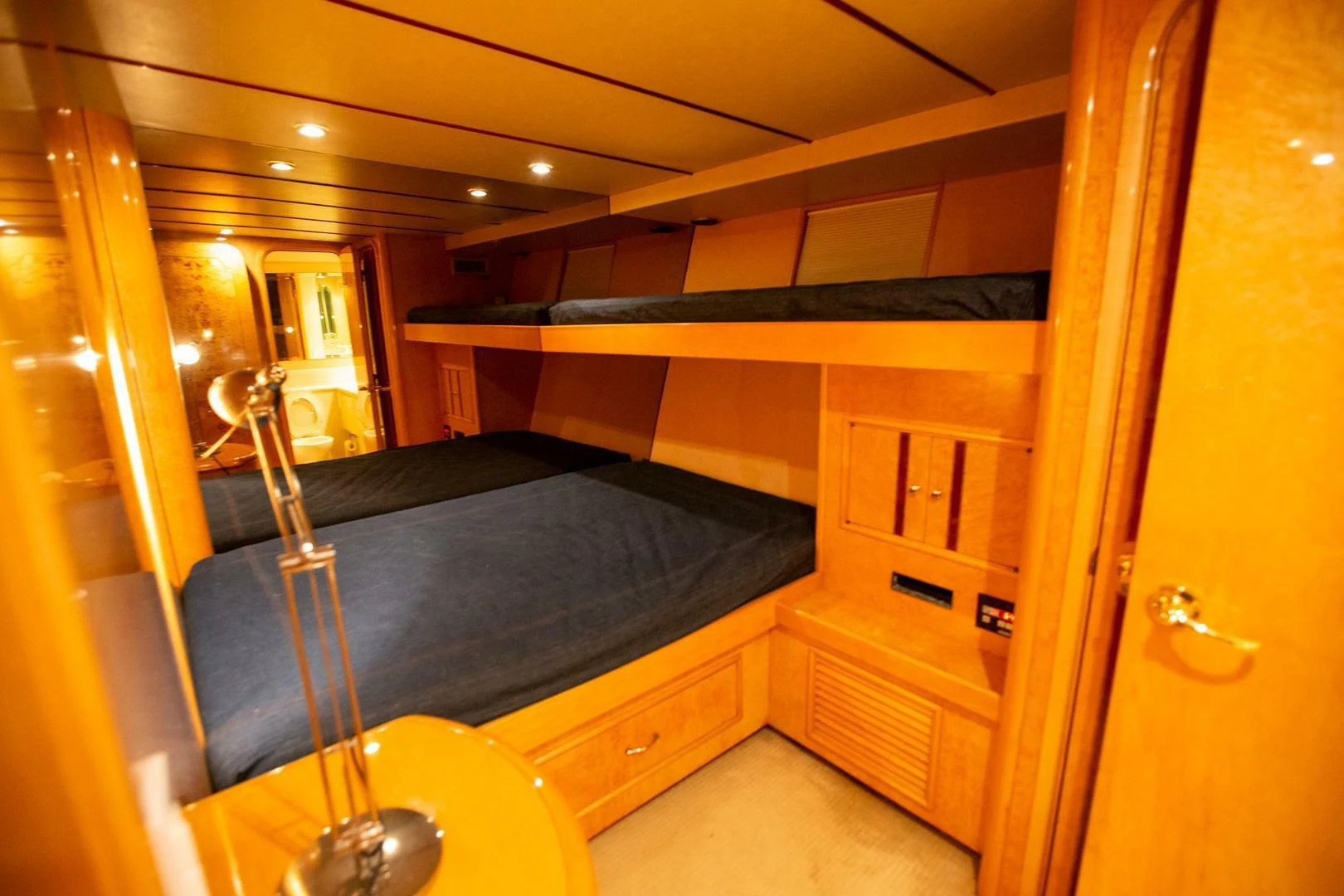 a bedroom with a bed and a desk aboard PAINKILLER Yacht for Sale