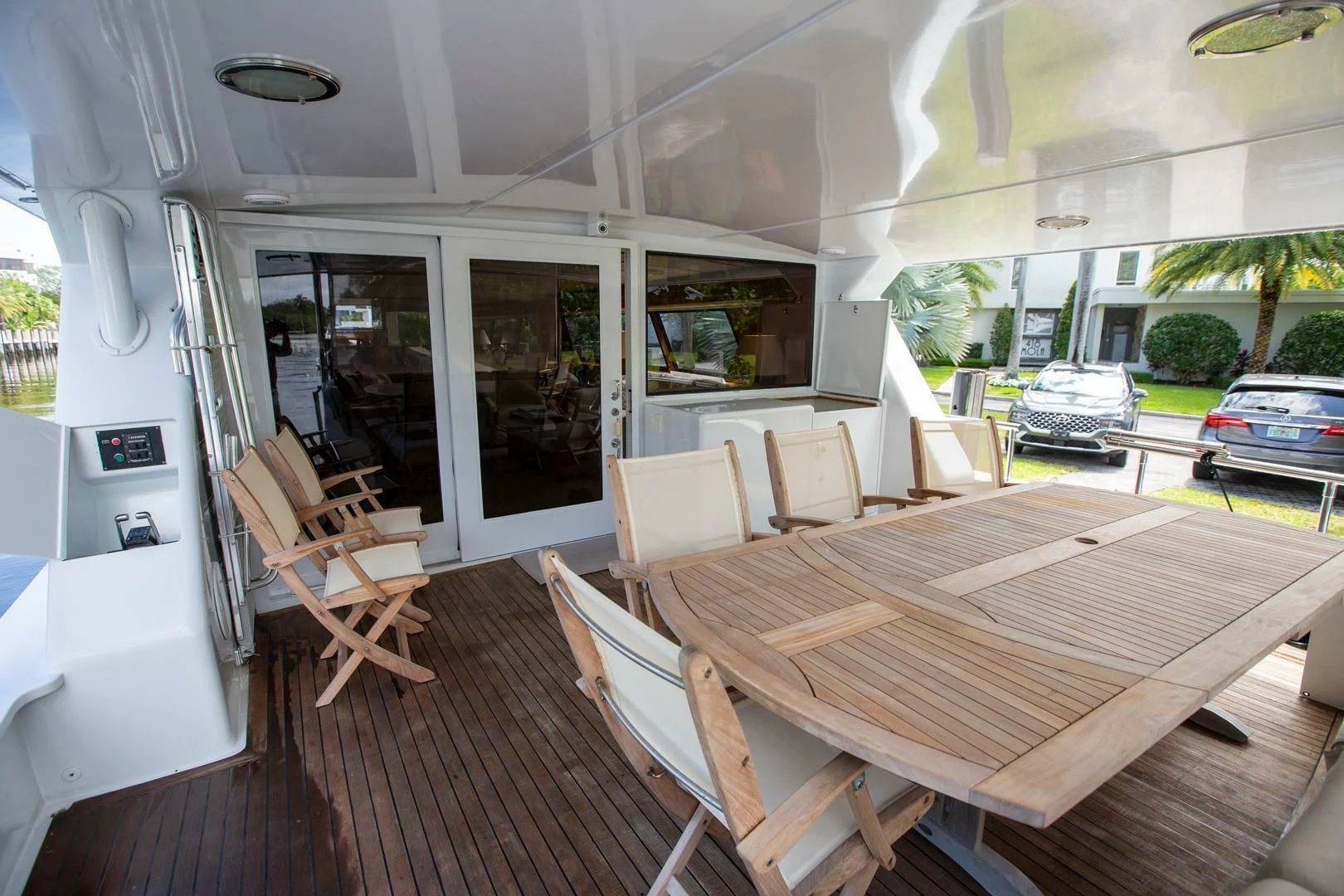 a room with a table chairs and a car aboard PAINKILLER Yacht for Sale