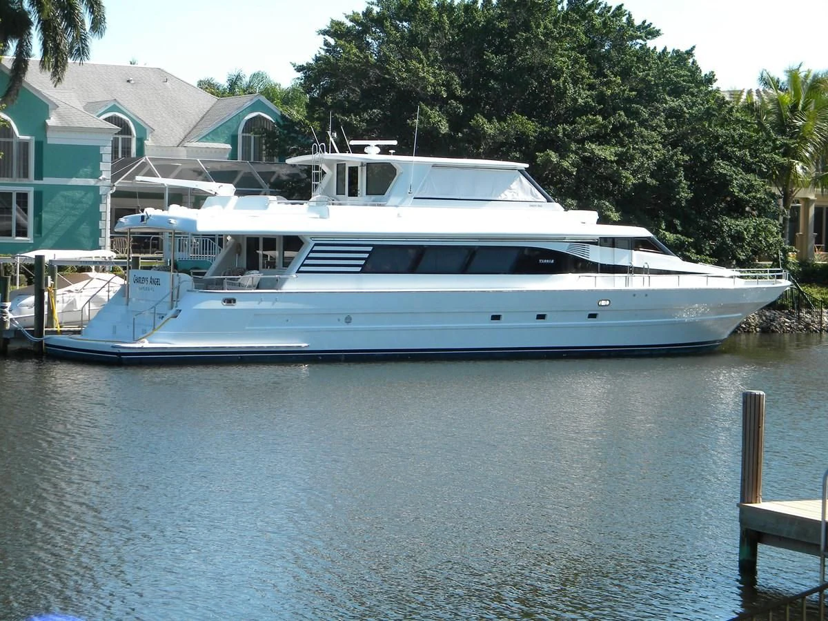 a large white boat in a body of water aboard PAINKILLER Yacht for Sale