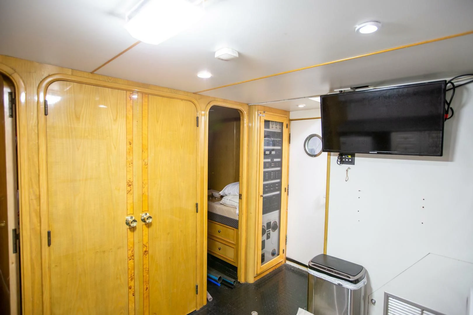 a room with a tv and a closet aboard PAINKILLER Yacht for Sale