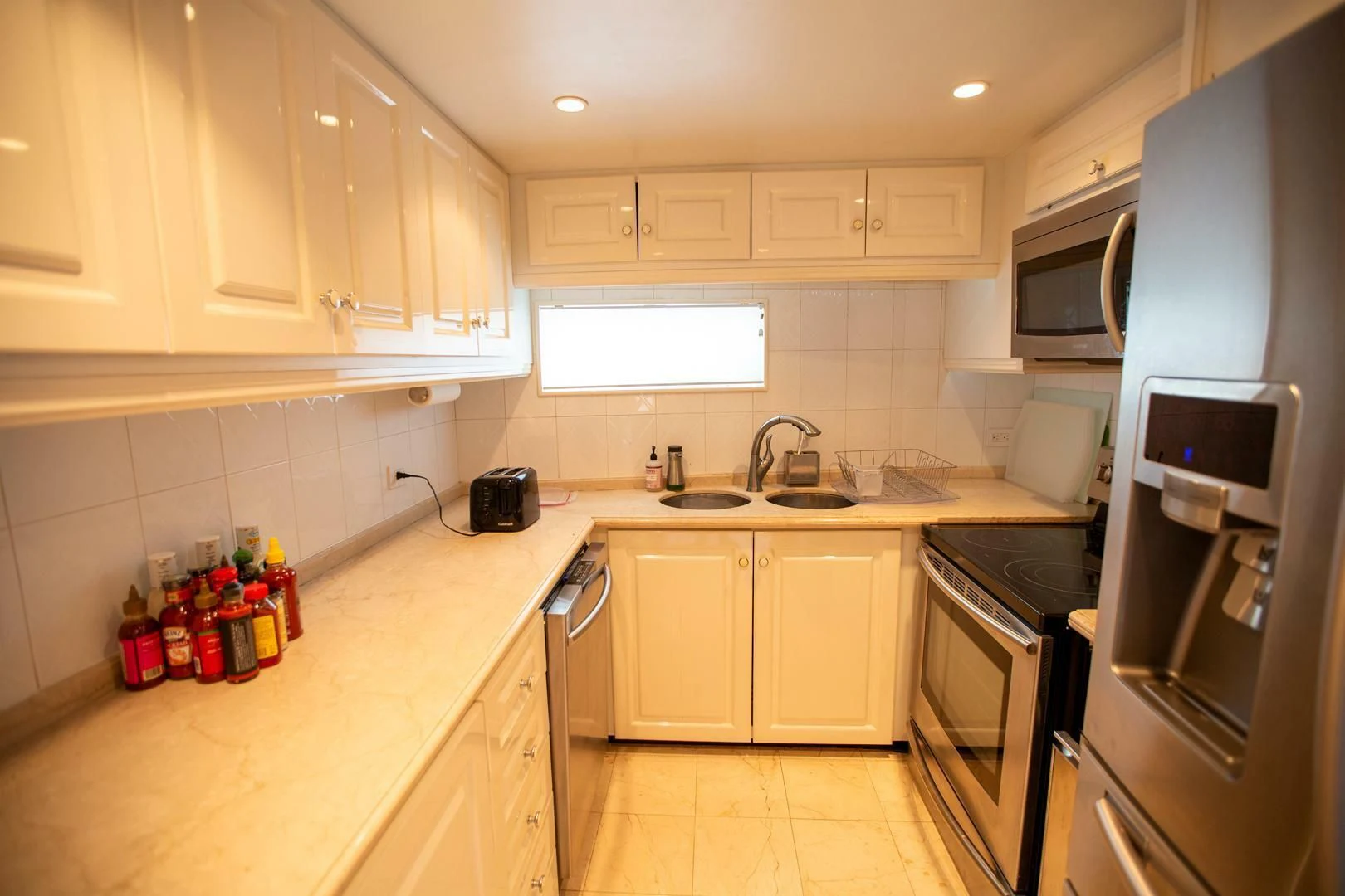 a kitchen with white cabinets aboard PAINKILLER Yacht for Sale