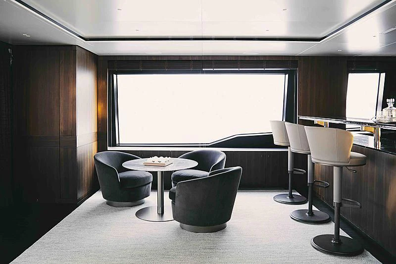 a room with a table chairs and a large window aboard BACCHANAL Yacht for Sale