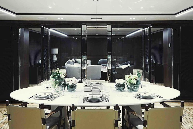 a table set for a formal dinner aboard BACCHANAL Yacht for Sale