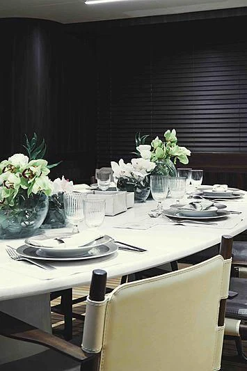 a table set with place settings aboard BACCHANAL Yacht for Sale