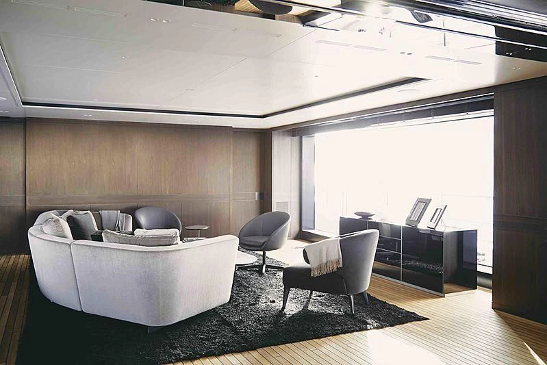 a room with a couch and a table aboard BACCHANAL Yacht for Sale