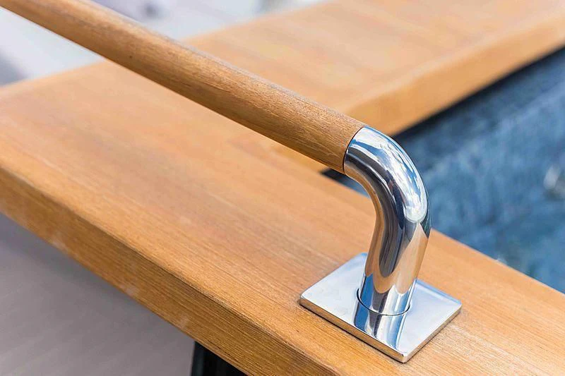 a wooden table with a metal object on it aboard BACCHANAL Yacht for Sale