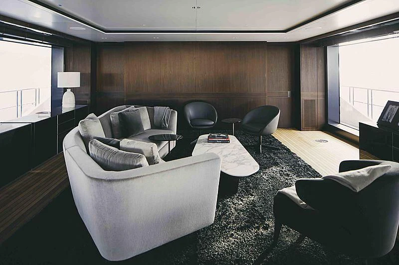 a room with a couch and a table aboard BACCHANAL Yacht for Sale