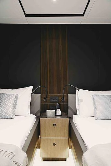 a room with a bed and a table aboard BACCHANAL Yacht for Sale