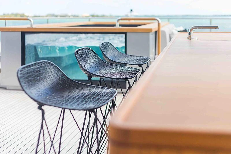 a couple of chairs on a deck aboard BACCHANAL Yacht for Sale