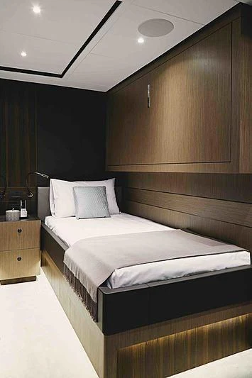 a bed with a white sheet aboard BACCHANAL Yacht for Sale