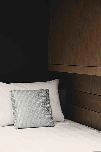 a bed with a white pillow aboard BACCHANAL Yacht for Sale