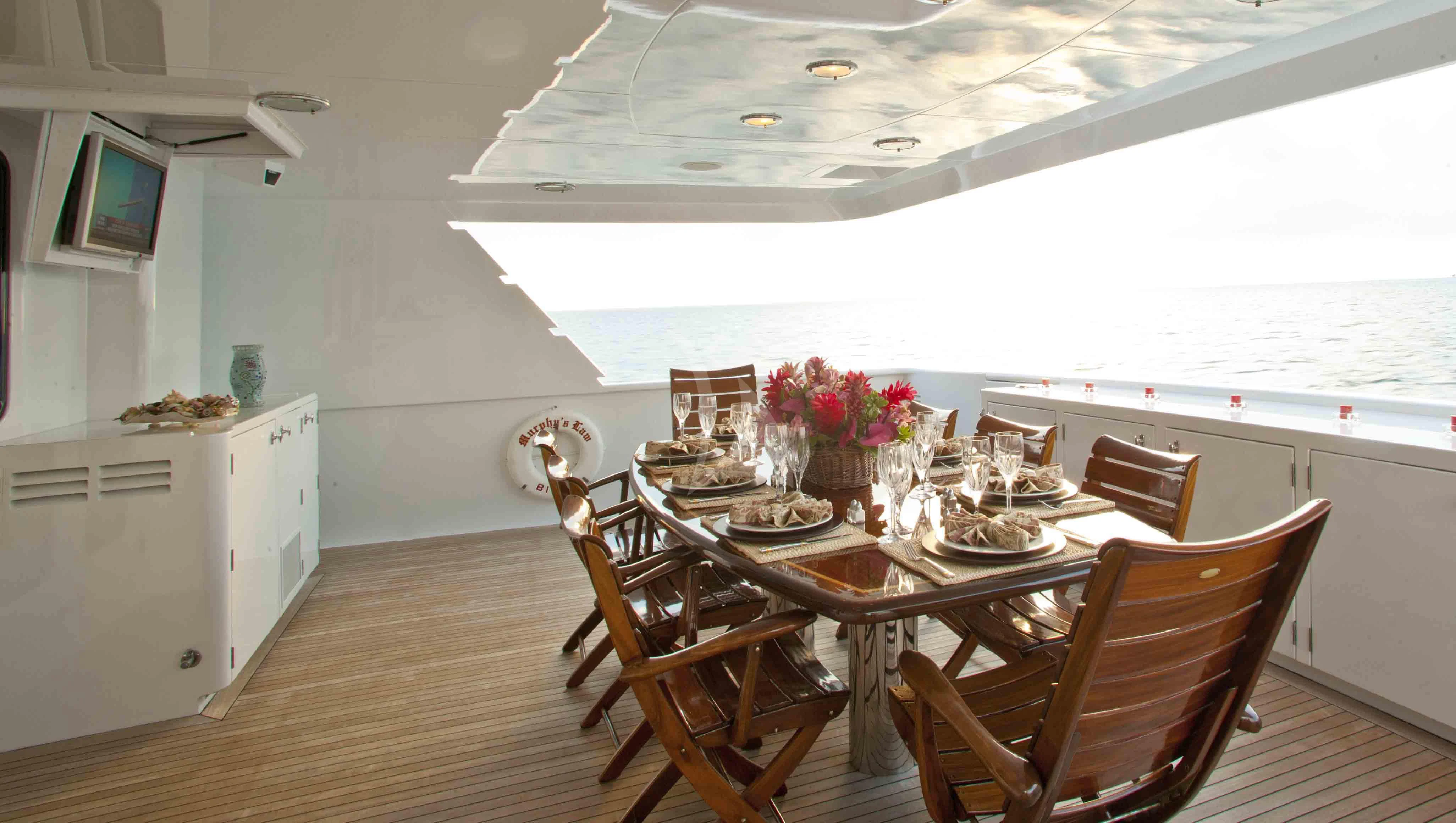 a dining room with a table and chairs aboard MURPHY'S LAW Yacht for Charter