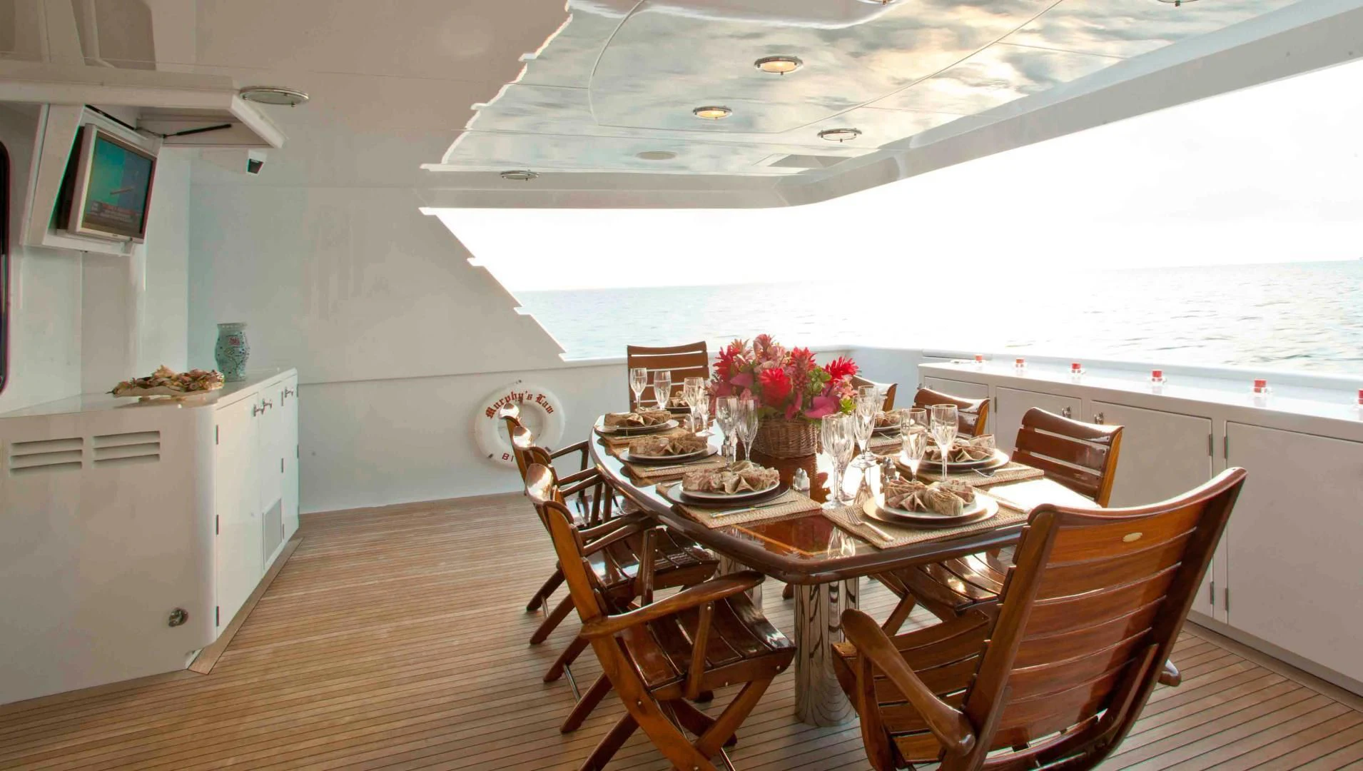 a dining room with a table and chairs aboard MURPHY'S LAW Yacht for Charter