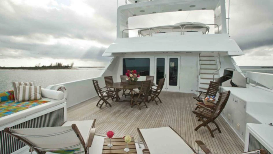 a living room with a large white boat on the water aboard MURPHY'S LAW Yacht for Charter