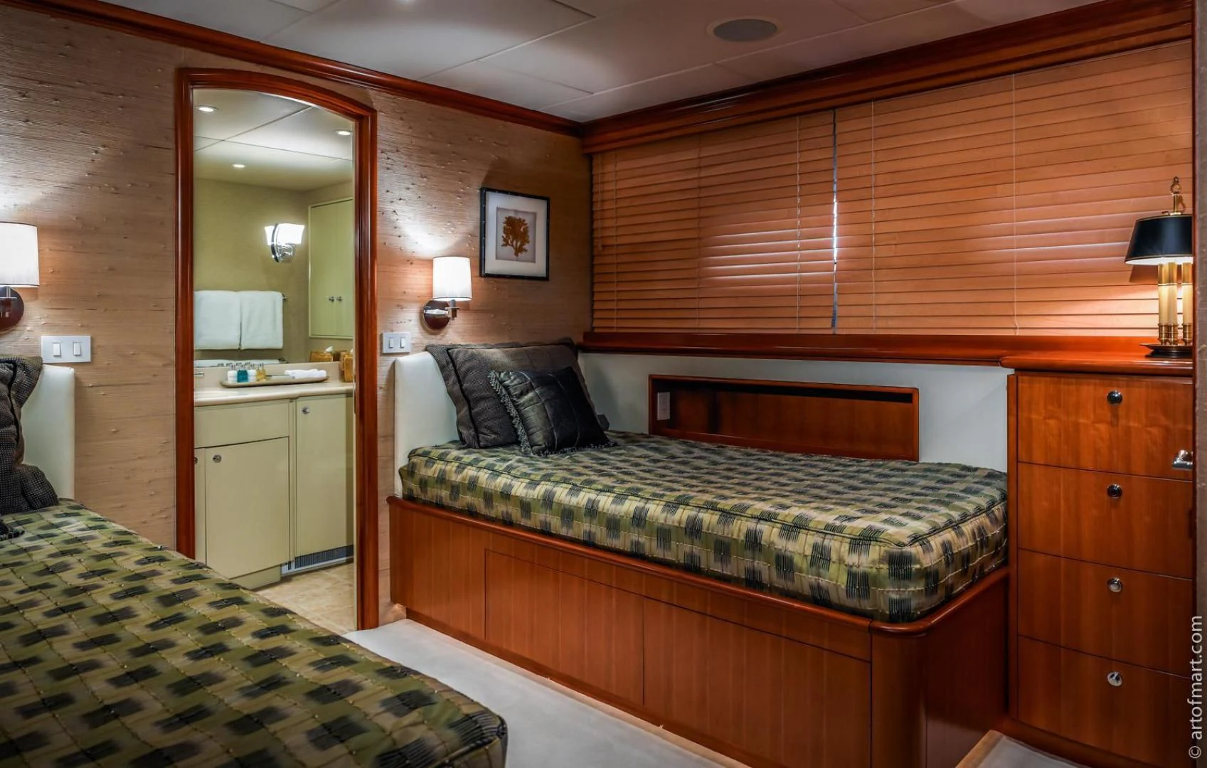 a bedroom with a bed and a mirror aboard MURPHY'S LAW Yacht for Charter