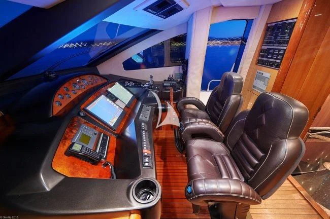 a leather chair next to a table aboard PEARL OF LONDON Yacht for Sale