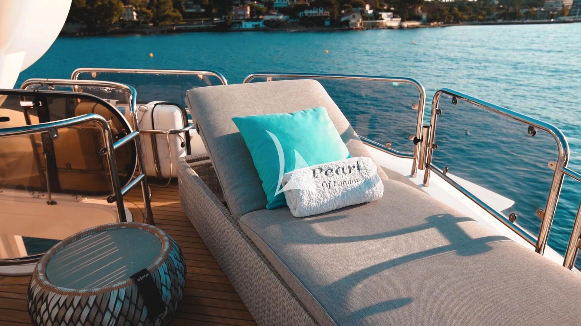 a deck with chairs and a table on it aboard PEARL OF LONDON Yacht for Sale