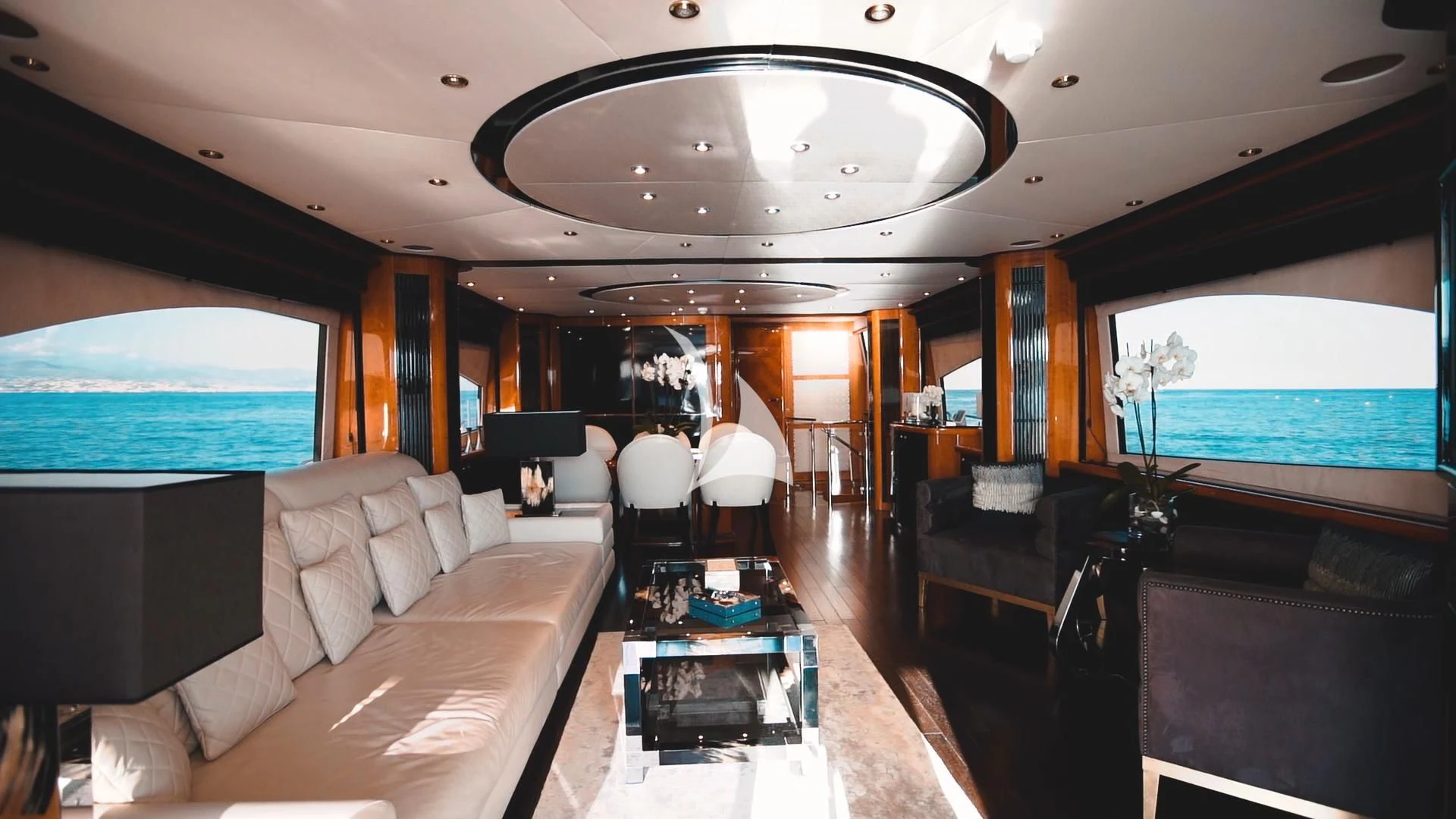 a room with a couch and a table and a television aboard PEARL OF LONDON Yacht for Sale