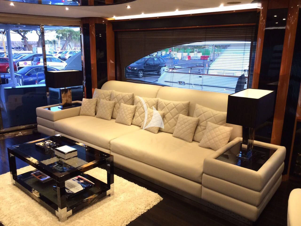 a living room with a large window aboard PEARL OF LONDON Yacht for Sale