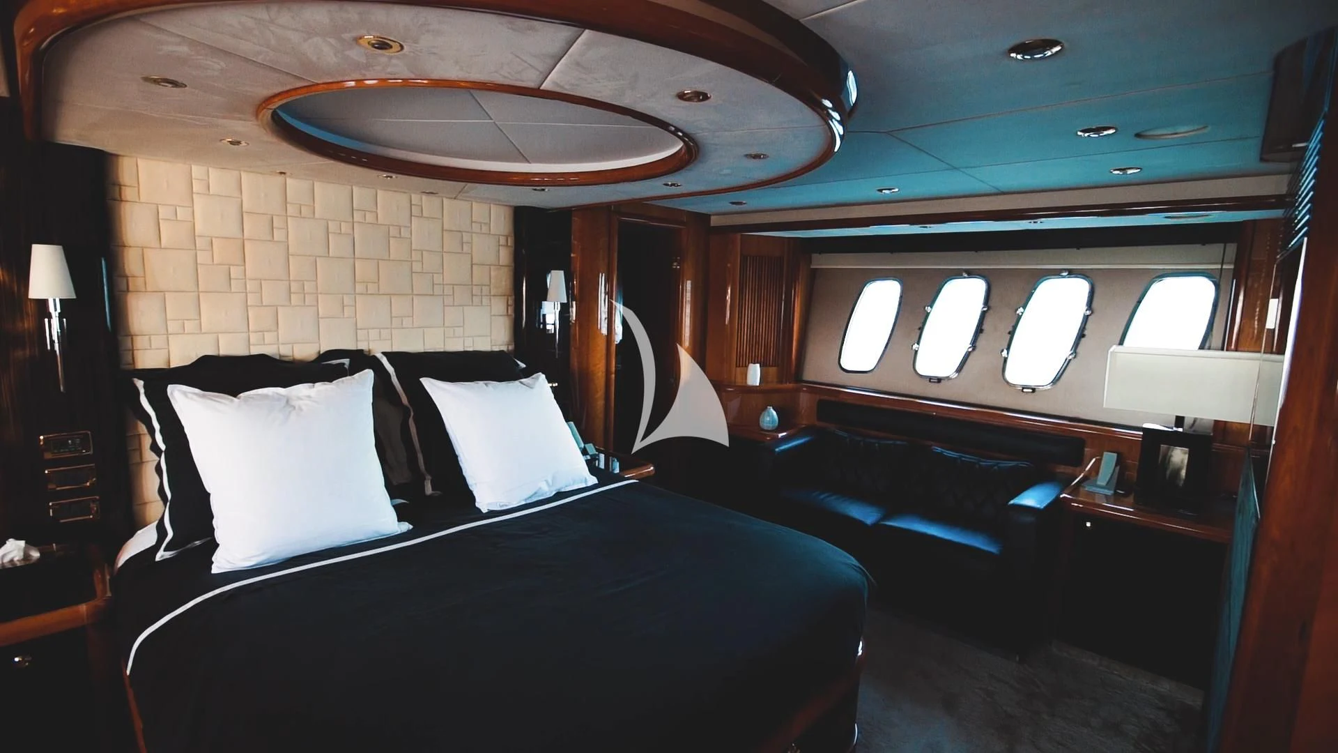 a room with a bed and a large mirror aboard PEARL OF LONDON Yacht for Sale