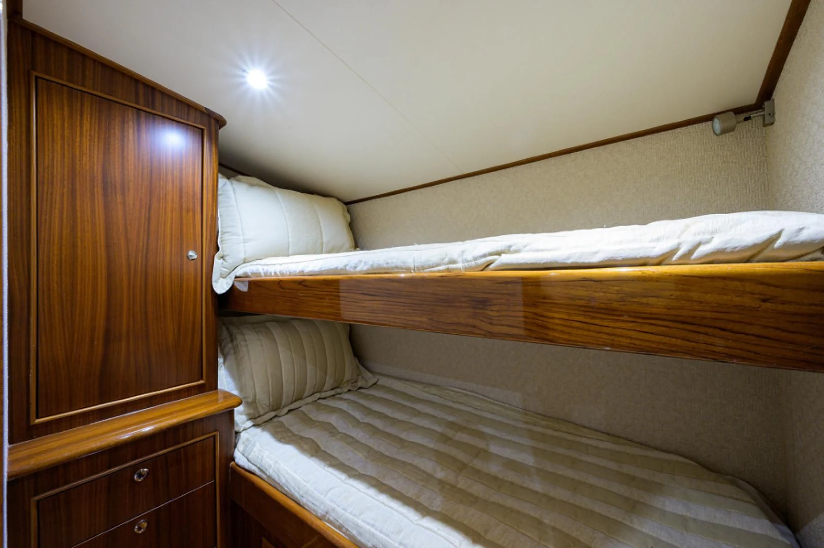 a bed with a wooden headboard aboard FLYING J Yacht for Sale