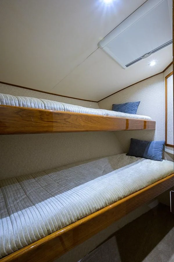 a bed with a wooden frame aboard FLYING J Yacht for Sale