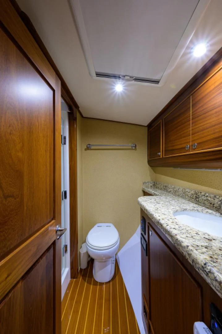 a bathroom with a toilet and sink aboard FLYING J Yacht for Sale